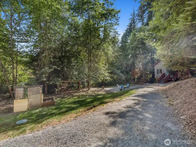 The expansive backyard is fully surrounded by trees, offering unmatched seclusion and a peaceful retreat.