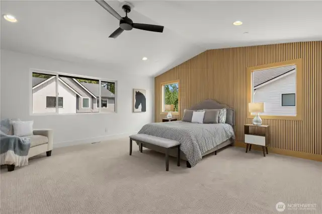 Upper level primary suite with vaulted ceilings