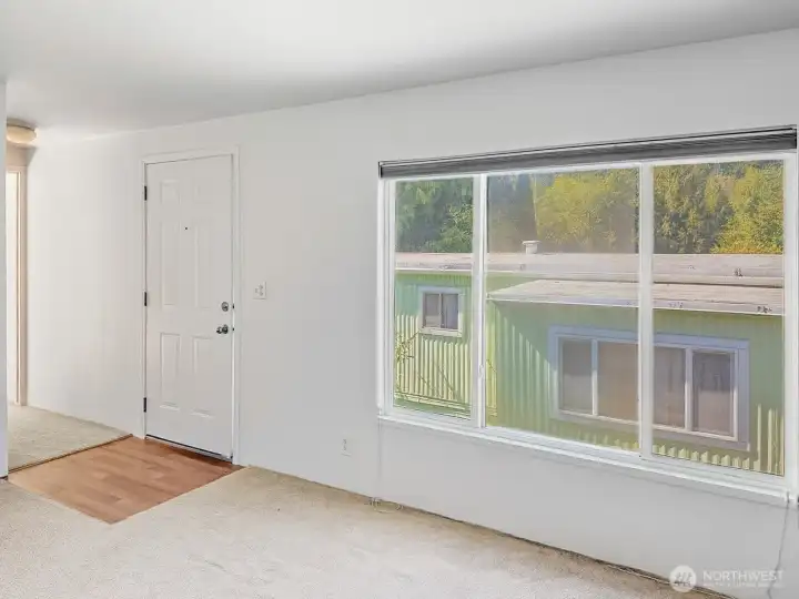 Sunlight pours through the large window, filling the living room with warmth.