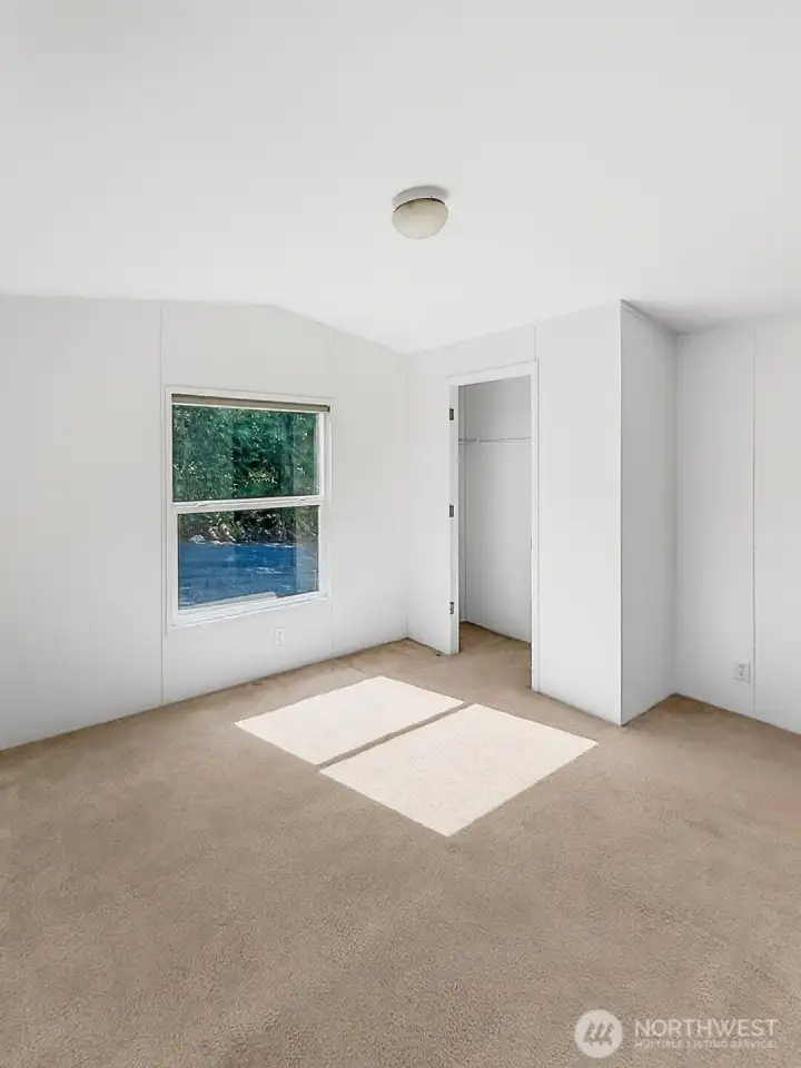 With generous closets and bright windows, this bedroom feels open and easy.