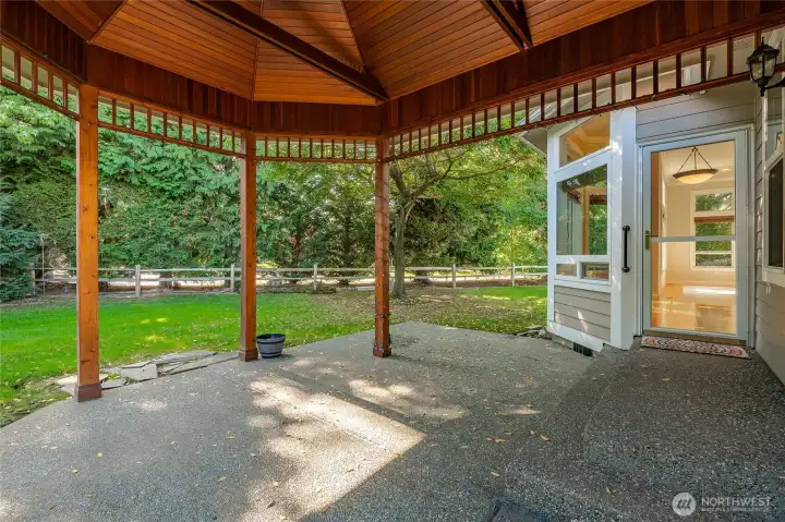 Large covered patio. Door leads into the dining area. Door to the Primary Bedroom to the right.