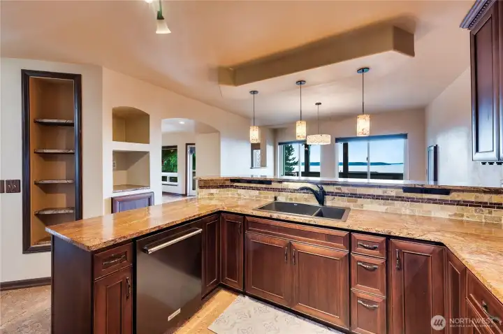 This fabulous kitchen features Marble countertops featuring petrified tree roots