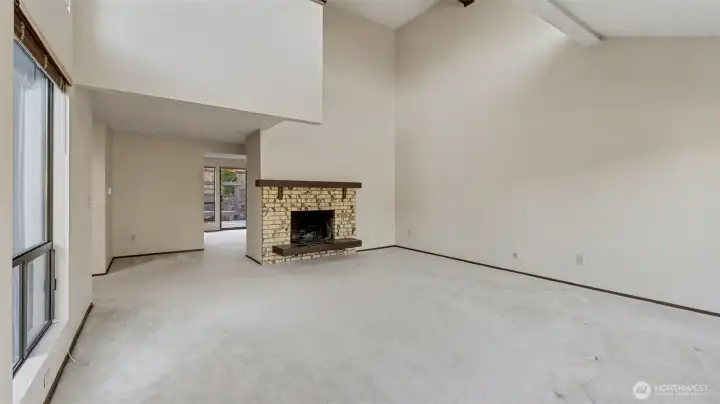 Soaring ceilings and a cozy fireplace create the perfect gathering space.