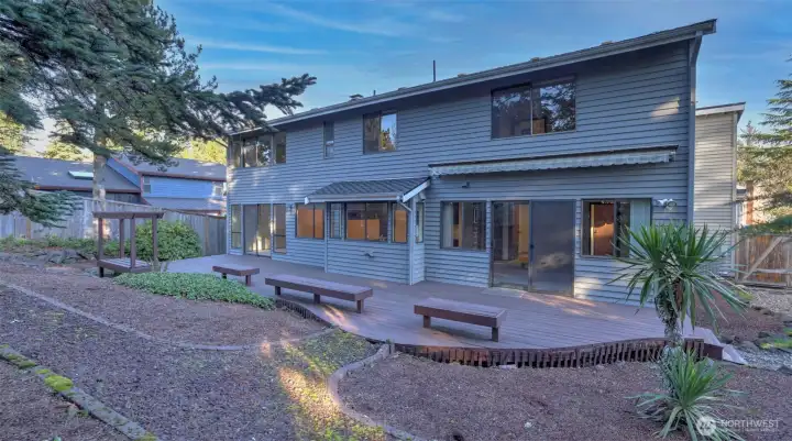A spacious deck surrounded by mature trees for year-round enjoyment.