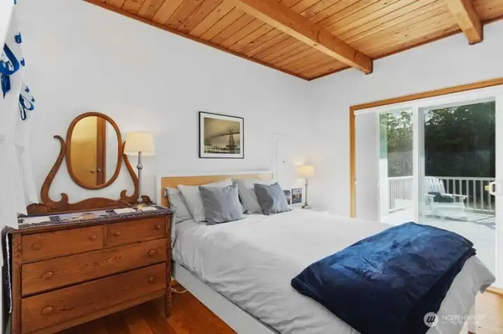 Comfortable main-level bedroom with sliding door access to the sunny south-facing deck.