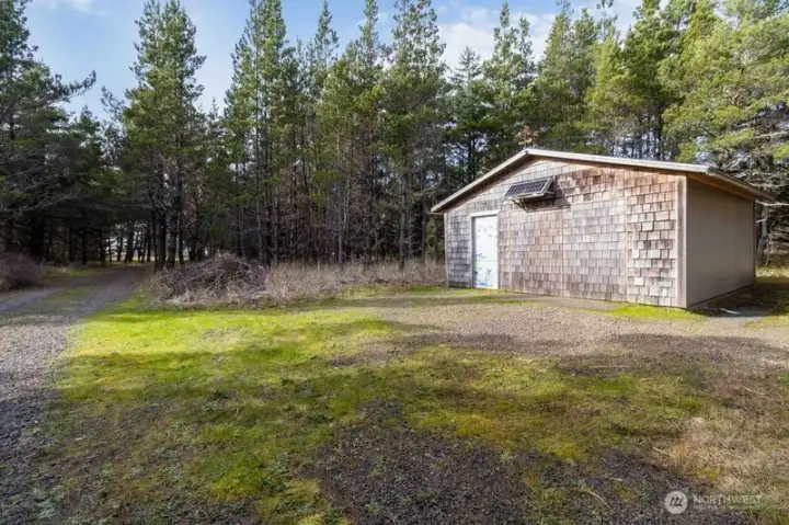 Spacious garage with room to park a vehicle and store beach gear.