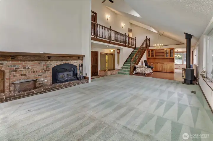 Living Room with Wood Burning Fireplace Insert Off Dining Room