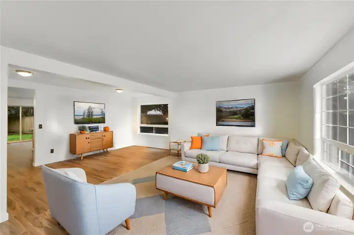 Here is your virtually staged large living-dining room with new lvp flooring and new interior paint