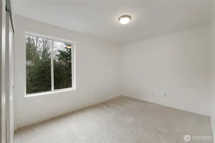 Bedroom #3 with new paint and lighting at back of home