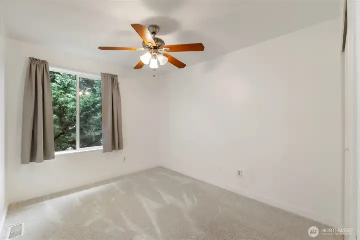 View of bedroom #4 with ceiling fans and big window too look out