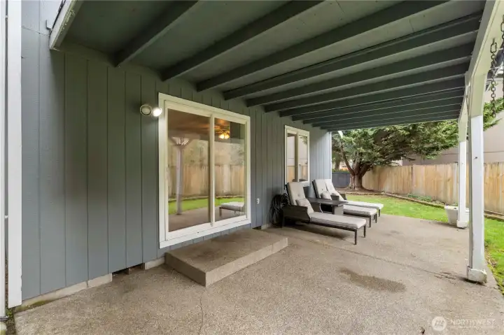 Big covered patio off back of home to stay dry and relax on lawn chairs year around