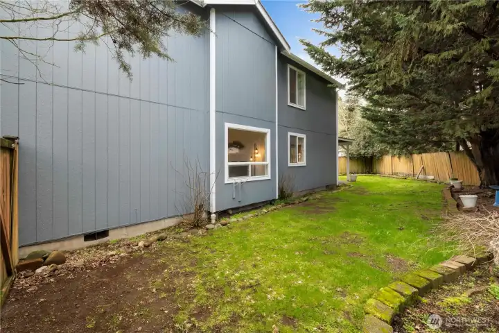 side yard view with lots of privacy from treees.  There is newer exterior paint also