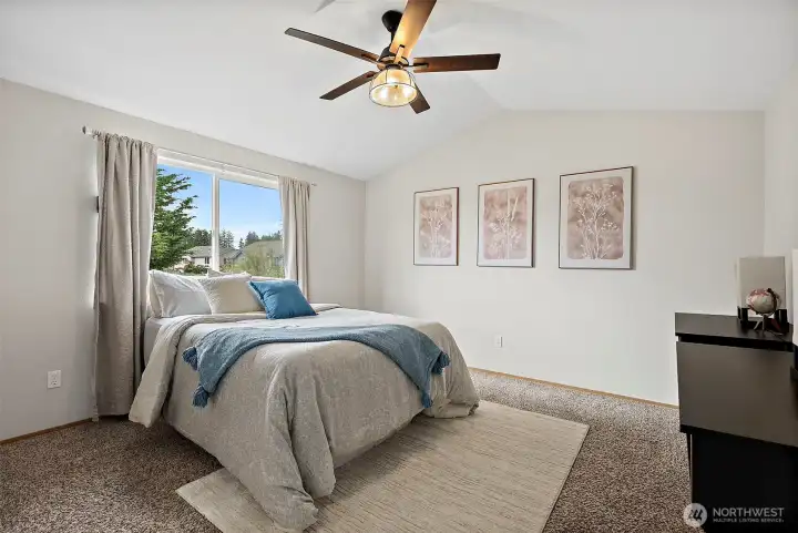 Large primary suite with vaulted ceiling.