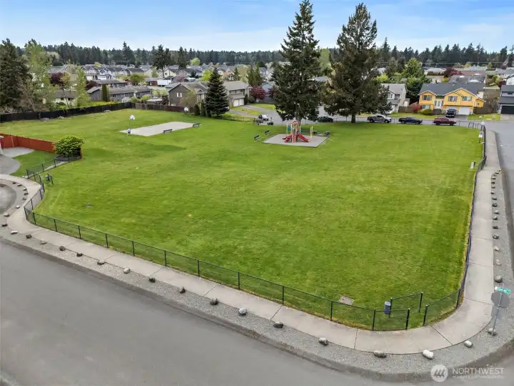 This community park is located right across the street. And it has a play ground, large grassy field, and basketball court.