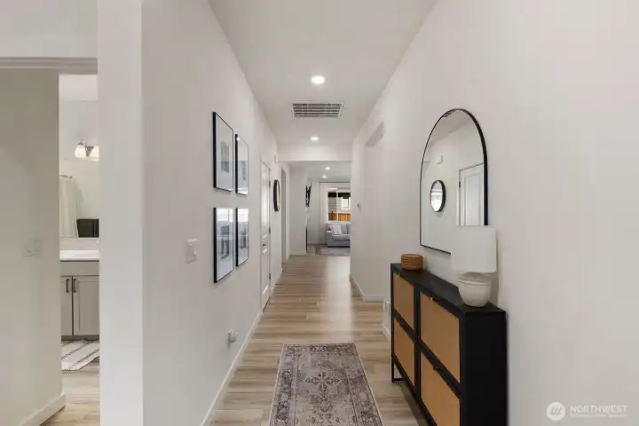 A wide entry hallway, 9-foot ceilings, and durable flooring create an inviting introduction to the home's open-concept design.