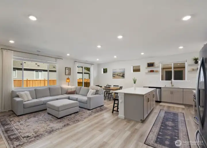 The heart of the home brings together the great room, kitchen, and dining area, creating a seamless space for everyday living and entertaining.