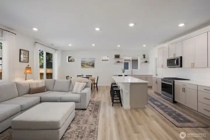 The open-concept layout allows the kitchen, dining area, and great room to work together seamlessly, making the home feel both spacious and connected.