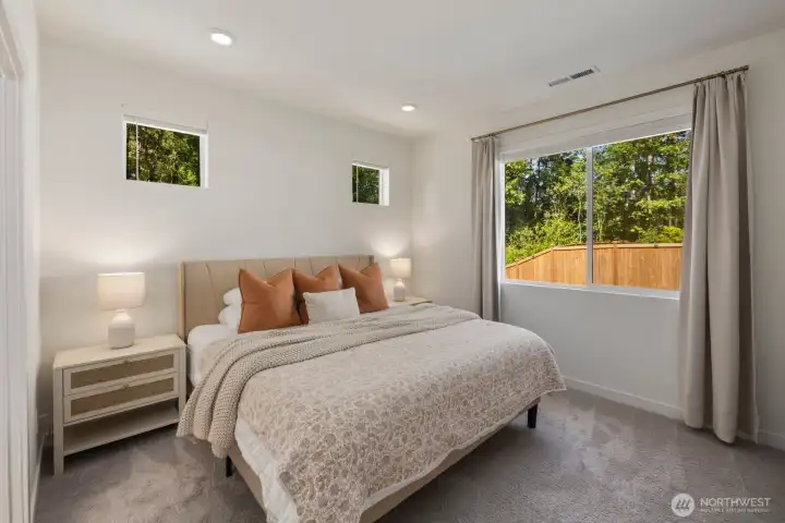 The primary suite offers a peaceful retreat with generous natural light and a layout designed for comfort at the end of the day.