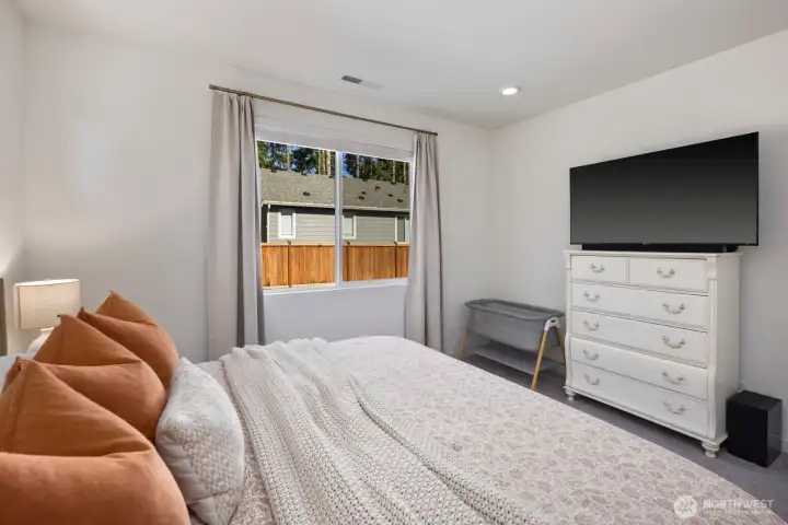 Spacious and inviting, the primary suite provides room to relax while remaining connected to the home's single-story layout.