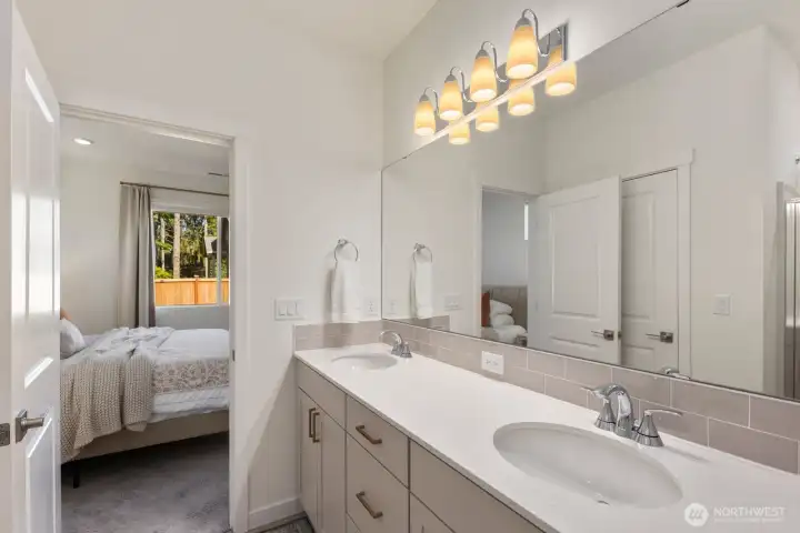With double sinks, ample counter space, and direct access from the primary suite, this bathroom blends everyday function with comfortable living.