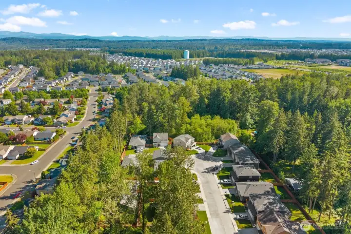 The setting is hard to miss from above, with established neighborhoods, open views, and a backdrop of Pacific Northwest scenery stretching in every direction.