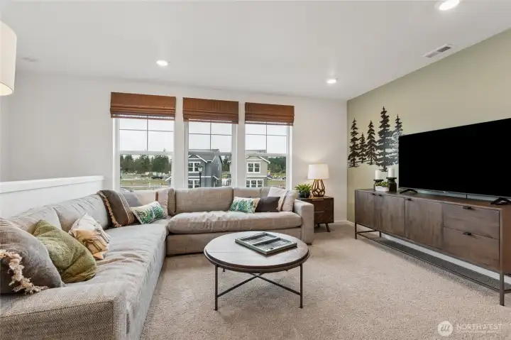 Versatile upstairs loft ideal for a second living area, media room, or workspace.