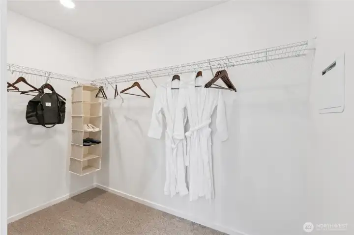 Spacious primary walk-in closet.