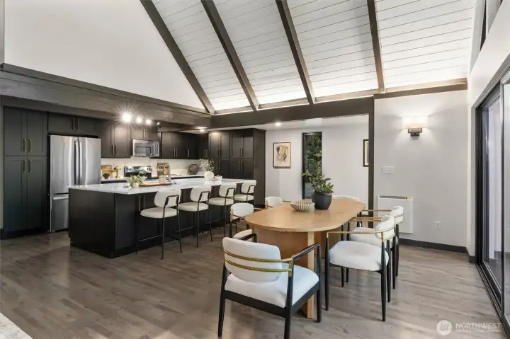 Experience the ultimate in open-concept living in this breathtaking contemporary residence. The centerpiece of the home is a dramatic great room defined by soaring wood ceilings with exposed architectural beams and an expansive wall of windows that seamlessly connects the indoors with nature.    Step into a space designed to take your breath away. This spectacular open-concept great room effortlessly pairs bold, contemporary lines with the organic warmth of soaring, all-wood beamed ceilings. But the true showstopper is the massive wall of windows—featuring 20-foot wide sliding glass doors that effortlessly glide open to blur the line between inside and out. The entire space flows seamlessly onto a huge custom deck, creating an unparalleled layout for summer entertaining or peaceful morning coffees. At the heart of it all sits a gourmet chef’s kitchen, complete with quartz countertops, an abundance of sleek cabinetry, glowing under-cabinet lighting. This is a "home experience"!
