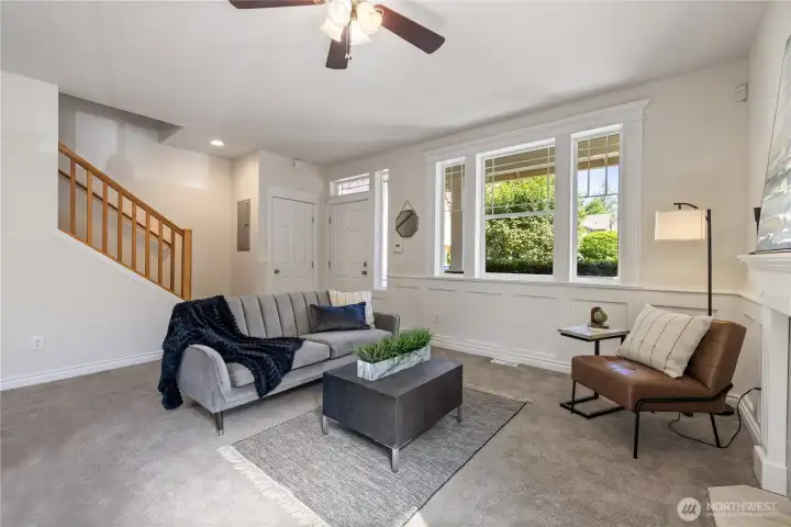 Another living room angle showing the staircase detail and how naturally bright the space stays throughout the day.