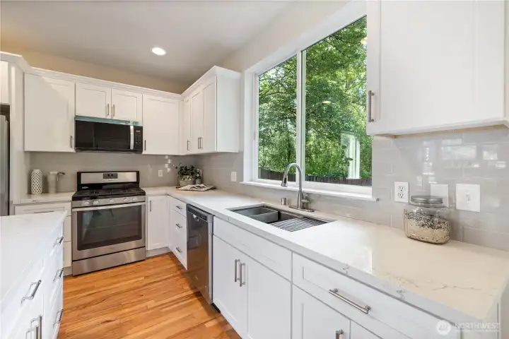 Full kitchen view showing the subway tile backsplash and stainless steel appliances