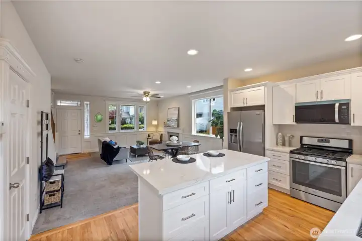 View from the back slider showing an open concept room with a bright and airy feel