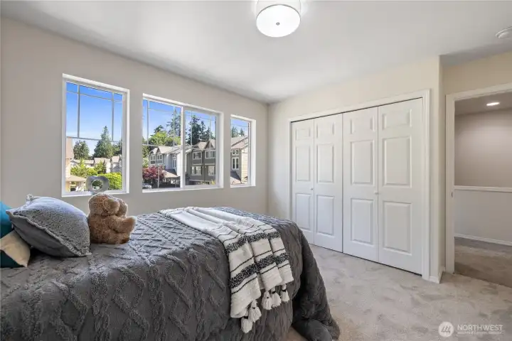 Bedroom with ample closet space and neutral tones ready for any style.