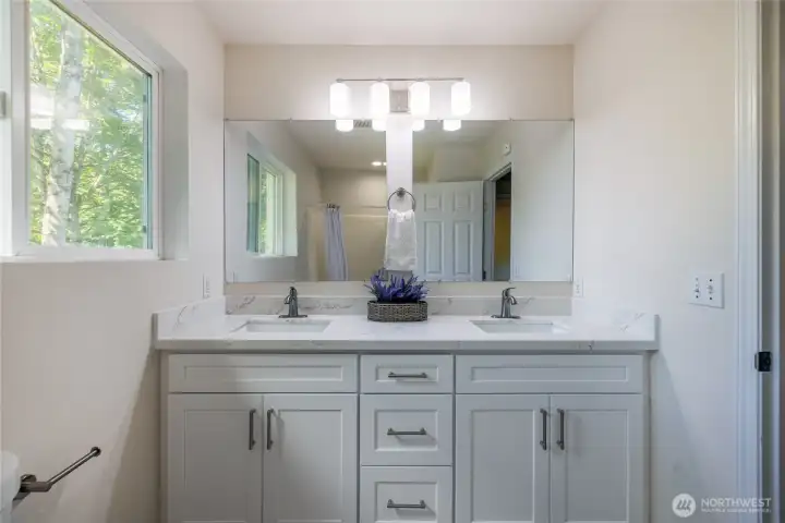 Updated double vanity with quartz countertops, undermount sinks, and brushed nickel hardware