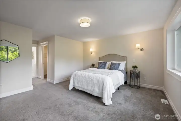 Second angle of the primary showing how spacious it is with room for a full furniture set.