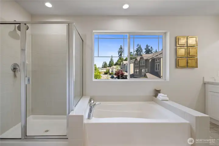 Walk-in shower detail — clean tile work and glass enclosure give it a spa-like feel