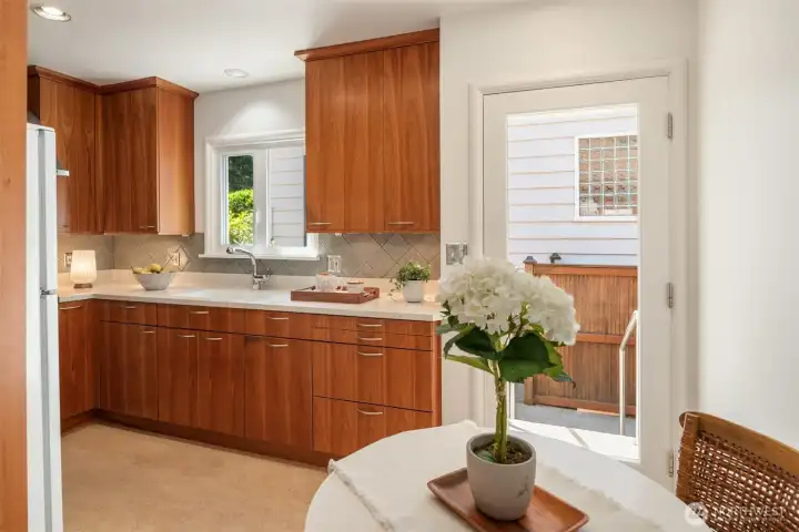 The kitchen is just off the dining area with room for a breakfast nook and access to the side yard though the back door. The kitchen is just off the dining area with room for a breakfast nook and access to the side yard though the back door.