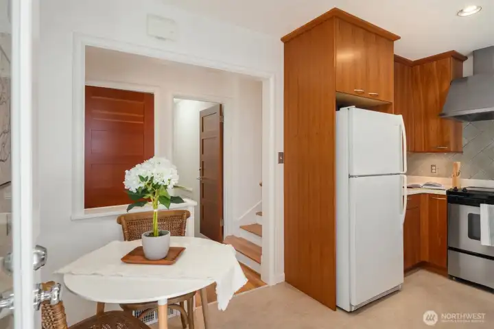 Kitchen eating nook or make it a space for an extra pantry or coffee bar. The open door goes to the lower level and the stairs to the right go to the two bedrooms and full bath. Kitchen eating nook or make it a space for an extra pantry or coffee bar. The open door goes to the lower level and the stairs to the right go to the two bedrooms and full bath.
