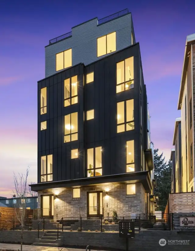 The community's striking design begins with a sleek dark façade and manicured landscaping!
