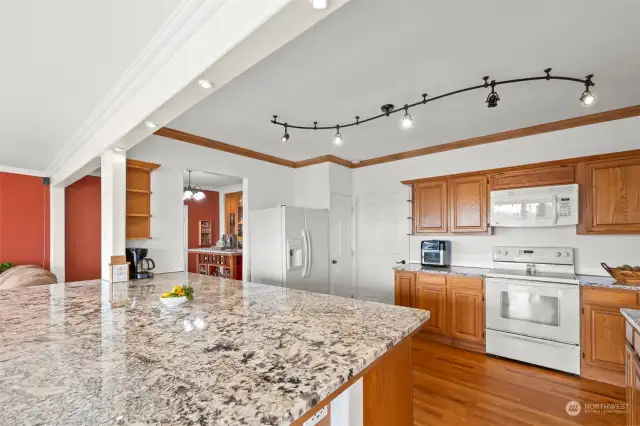 Spacious kitchen on main floor features the largest slab of granite countertop!