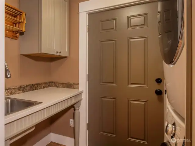 Laundry Room with sink, drying rack, folding area and table and washer/dryer