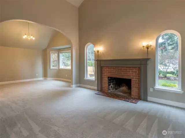 Living Room with wood fireplace looking into the Dining Room