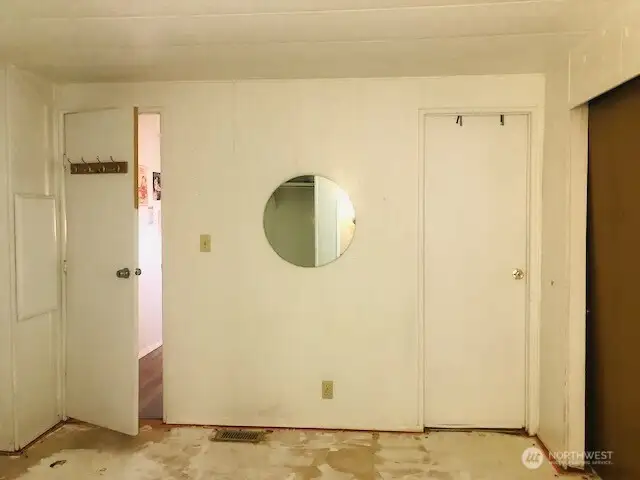 Primary Bedroom has door to the bathroom on the right and door to the hallway on the left.