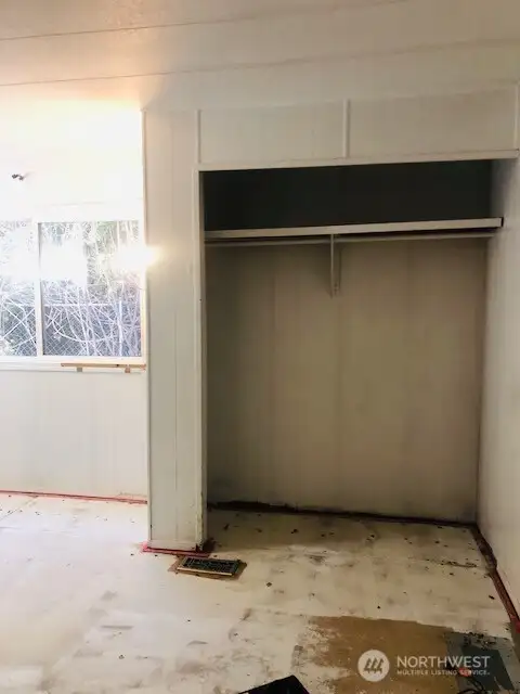 Primary Bedroom showing one of the 2 large closets. Carpets have been removed.