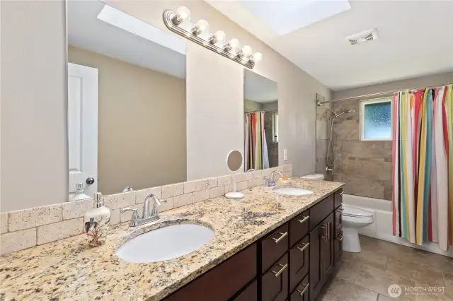 Full bathroom with double granite sinks