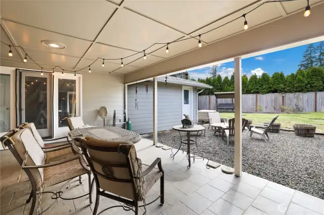 Relaxing and covered patio on slate in back yard