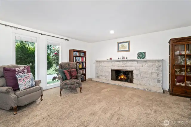 Living room with full windows and full fireplace.
