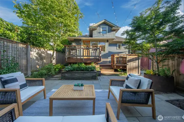 Meticulously curated garden & beautiful deck/patio makes this the coziest backyard to entertain all of your friends & family!