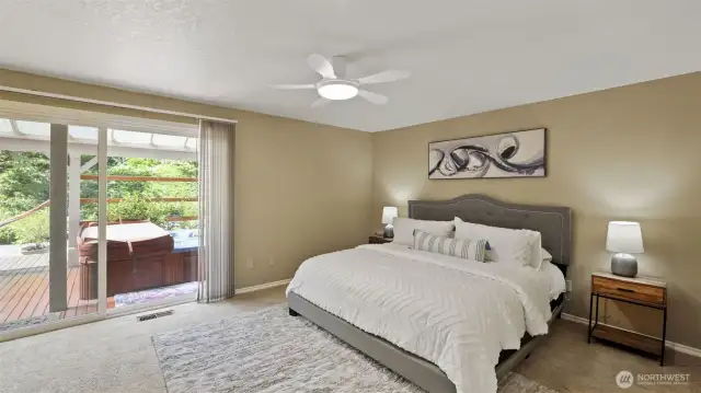 Enjoy private backyard access from the primary bedroom, where a relaxing hot tub awaits just beyond the sliding door.