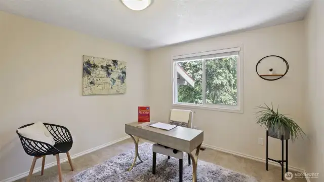 This upstairs guest room offers a flexible layout—perfect as a dedicated modern workspace or a comfortable sanctuary for guests.