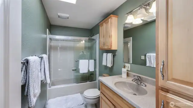 Conveniently located full guest bathroom just steps from the guest rooms, features ample storage—perfect for guests or daily use.